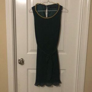 Green pleated dress with embellished neckline
